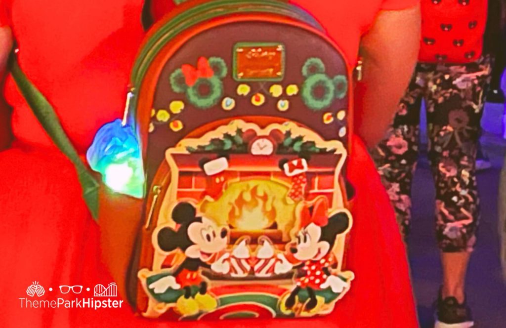 Mickey and Minnie Mouse at the fireplace. One of the best Disney Christmas Loungefly Bags for the Holidays
