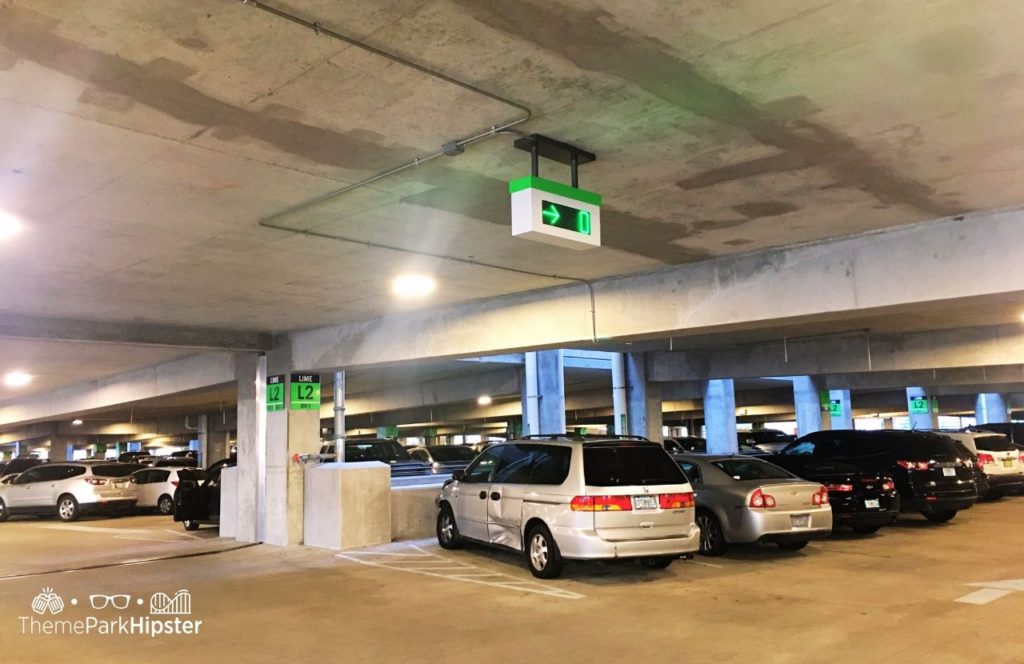 Walt Disney World Disney Springs Parking Lime Garage. Keep reading to learn more about the cost to park at Disney.