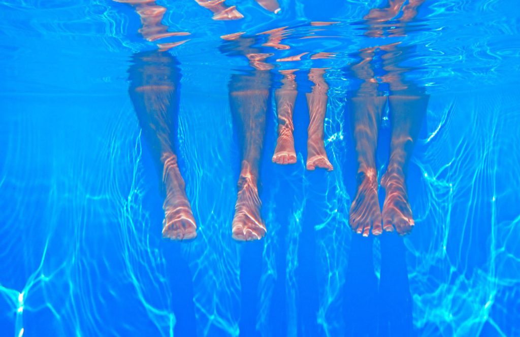 Feet in the pool at a water park