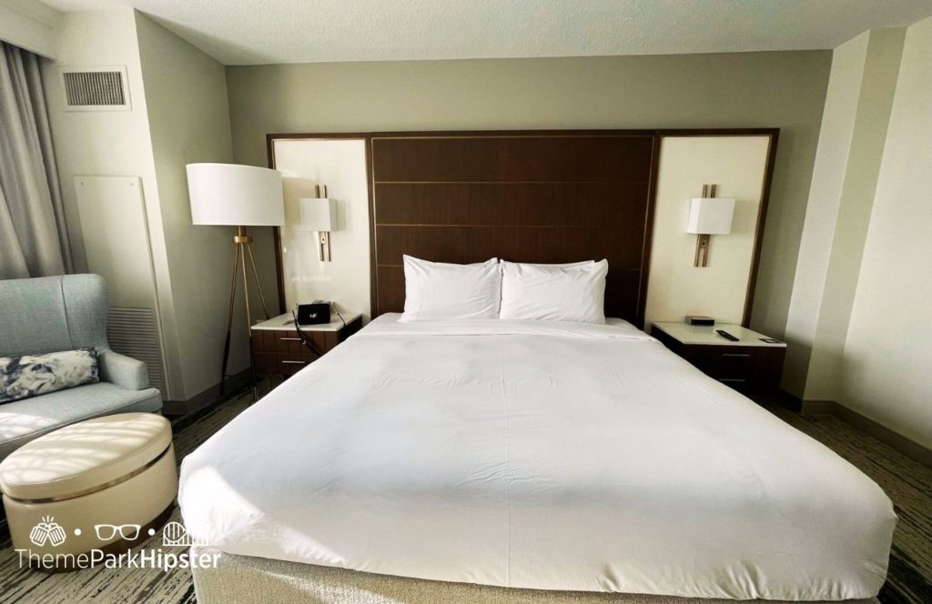 King Bedroom with sitting area nand lamp fixtures at Hilton Signia Hotel at Disney World. Keep reading to learn all you need to know about Signia by Hilton Orlando Bonnet Creek.