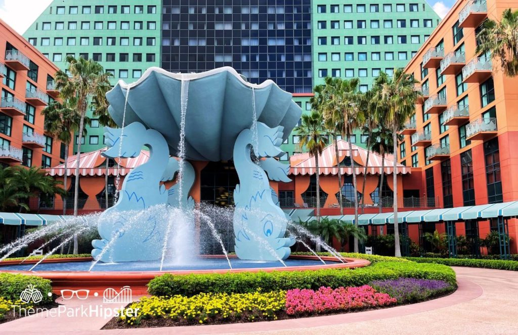 Swan and Dolphin Resort Hotel at Walt Disney World with large aquatic water fountain out front. Keep reading for the full guide to Disney World Passholder benefits.