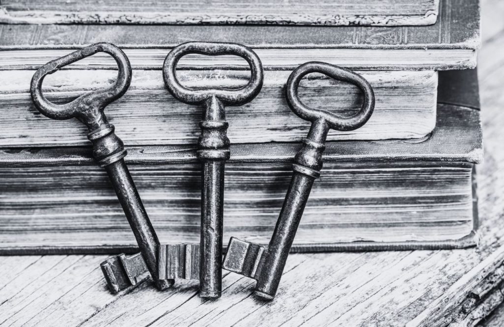 American Escape Rooms - Orlando  with a black and white photo of antique style  keys. Keep reading to find out more about the best escape room in Orlando.